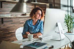 Hiring manager working at computer posting new jobs