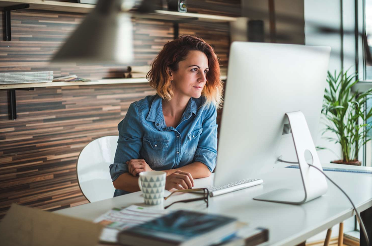 Hiring manager working at computer posting new jobs